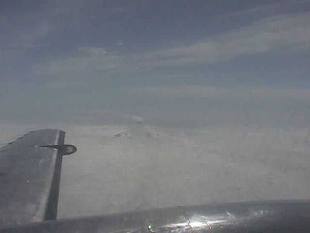 Smoking Aleutian Volcano from airplane